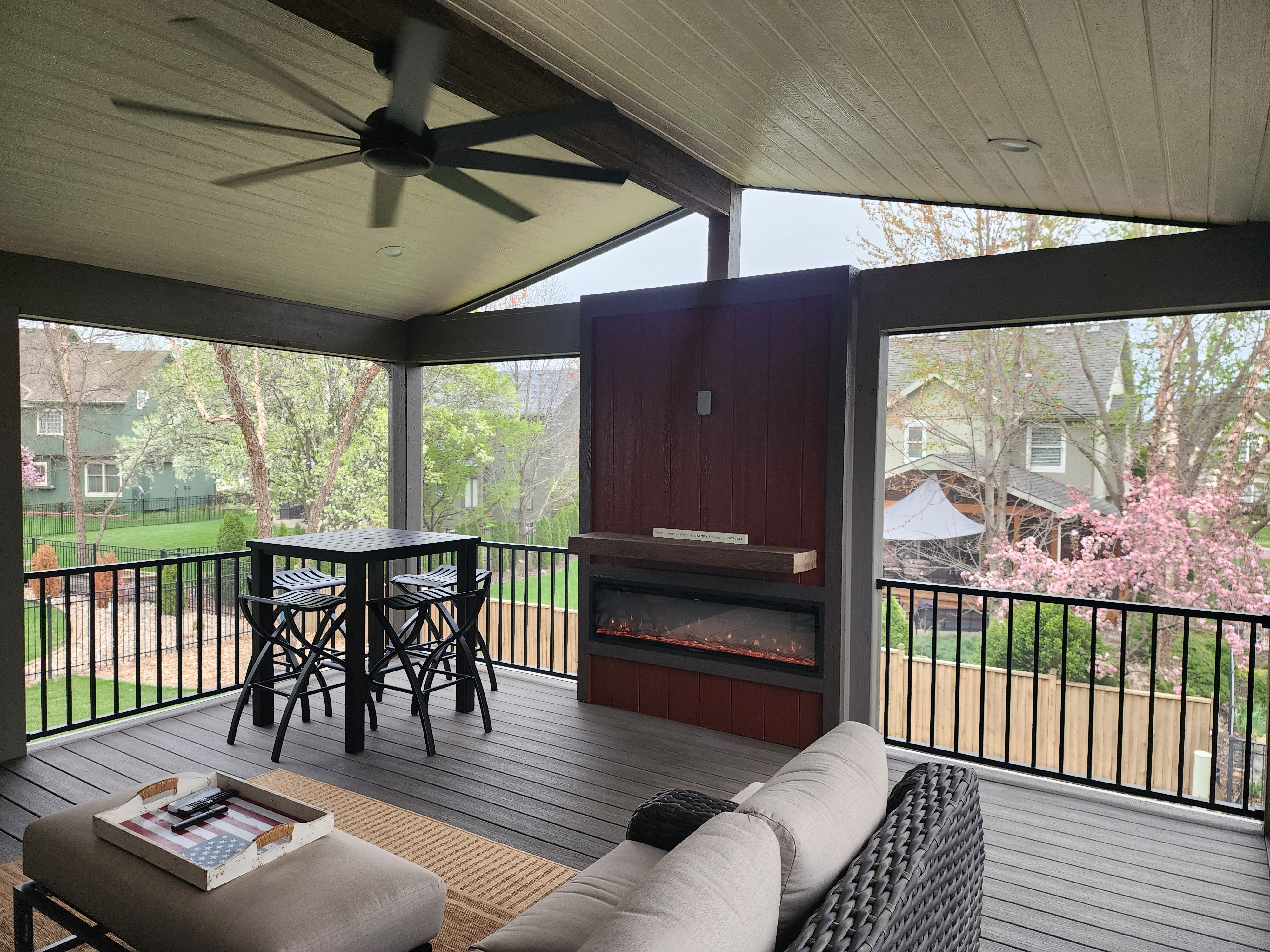 Covered deck with an outdoor fireplace