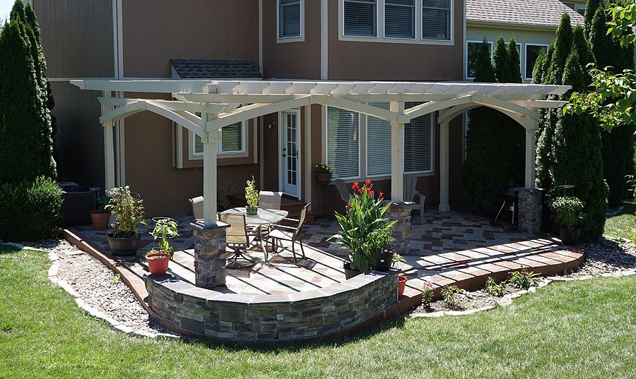Elegant white vinyl pergola on a stone patio